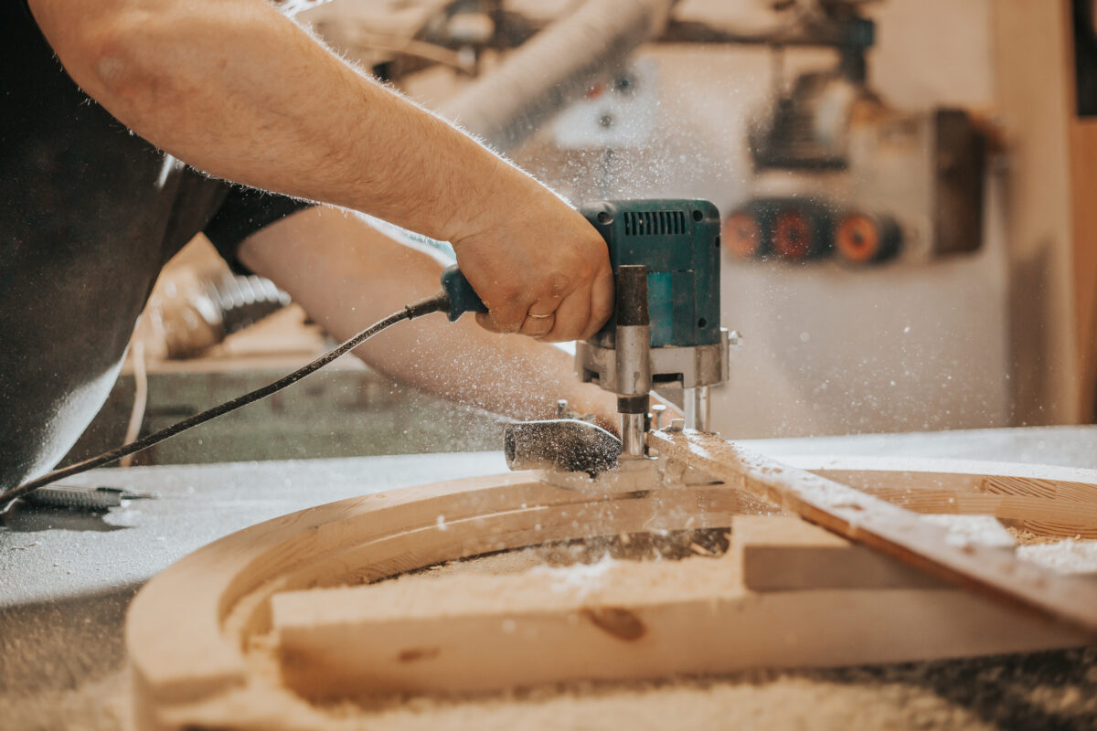 Joinery, woodworking, furniture making, professional carpenter cutting wood in carpentry shop, industrial concept