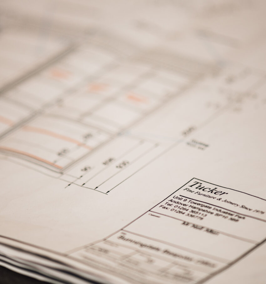 A close up of a woodworking drawing, focusing on the Tucker Joinery branding on the corner of the page.