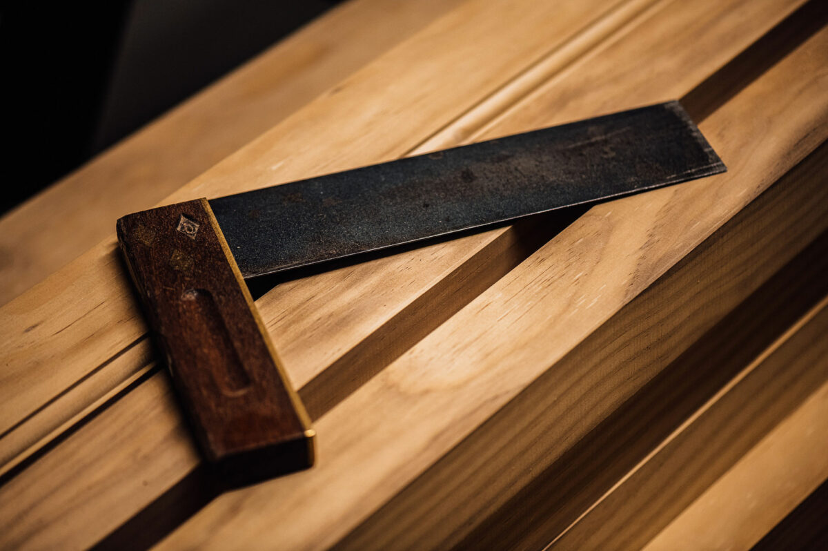 An L-shaped woodworking tool sits atop a workbench in the Tucker Joinery workshop, Andover.