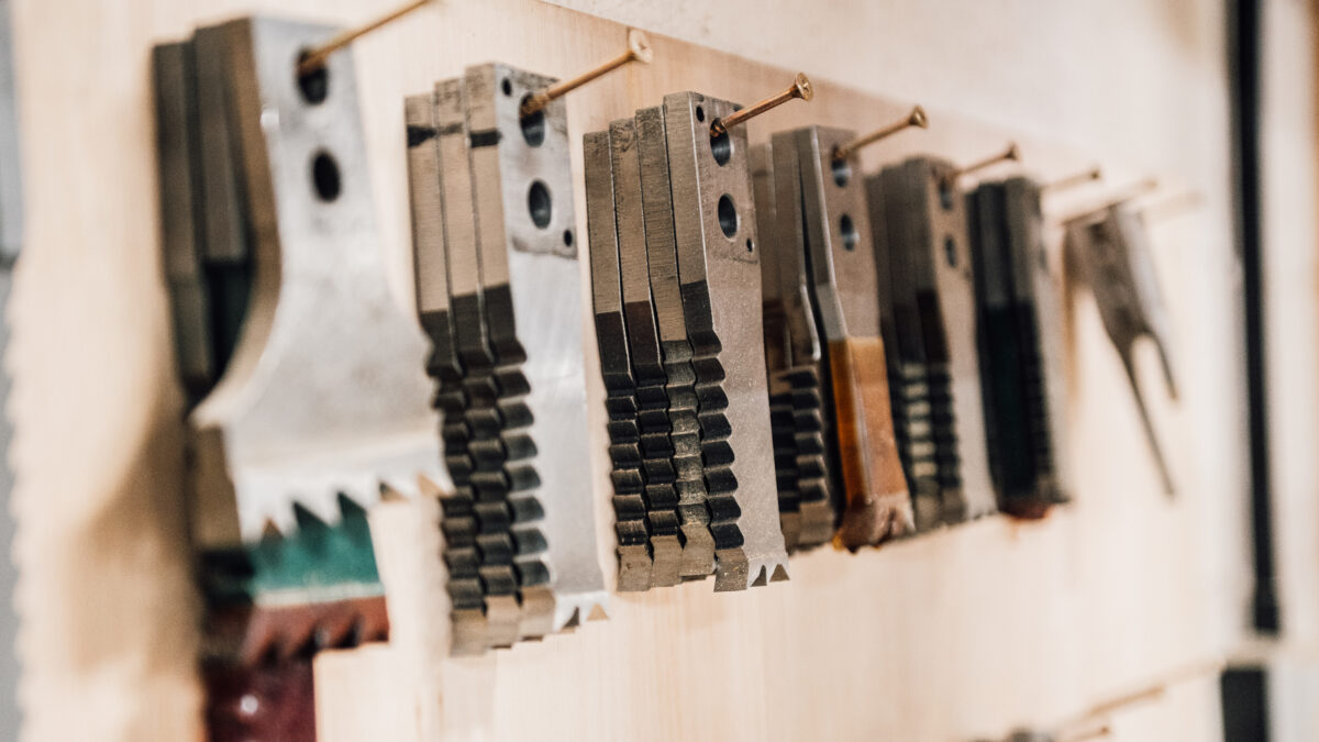 A collection of replacement saw blades, for woodworking, hand on the wall at the Tucker Joinery workshop.