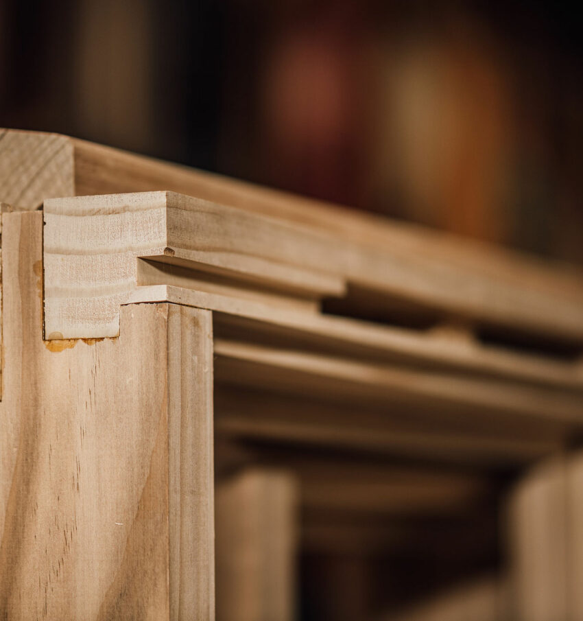 A close up of the corner joinery of a timber frame sitting in the Tucker Joinery workshop, based in Andover.