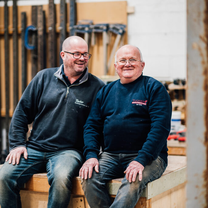 Dave and Lee Tucker, sitting together in the Tucker Joinery Workshop.