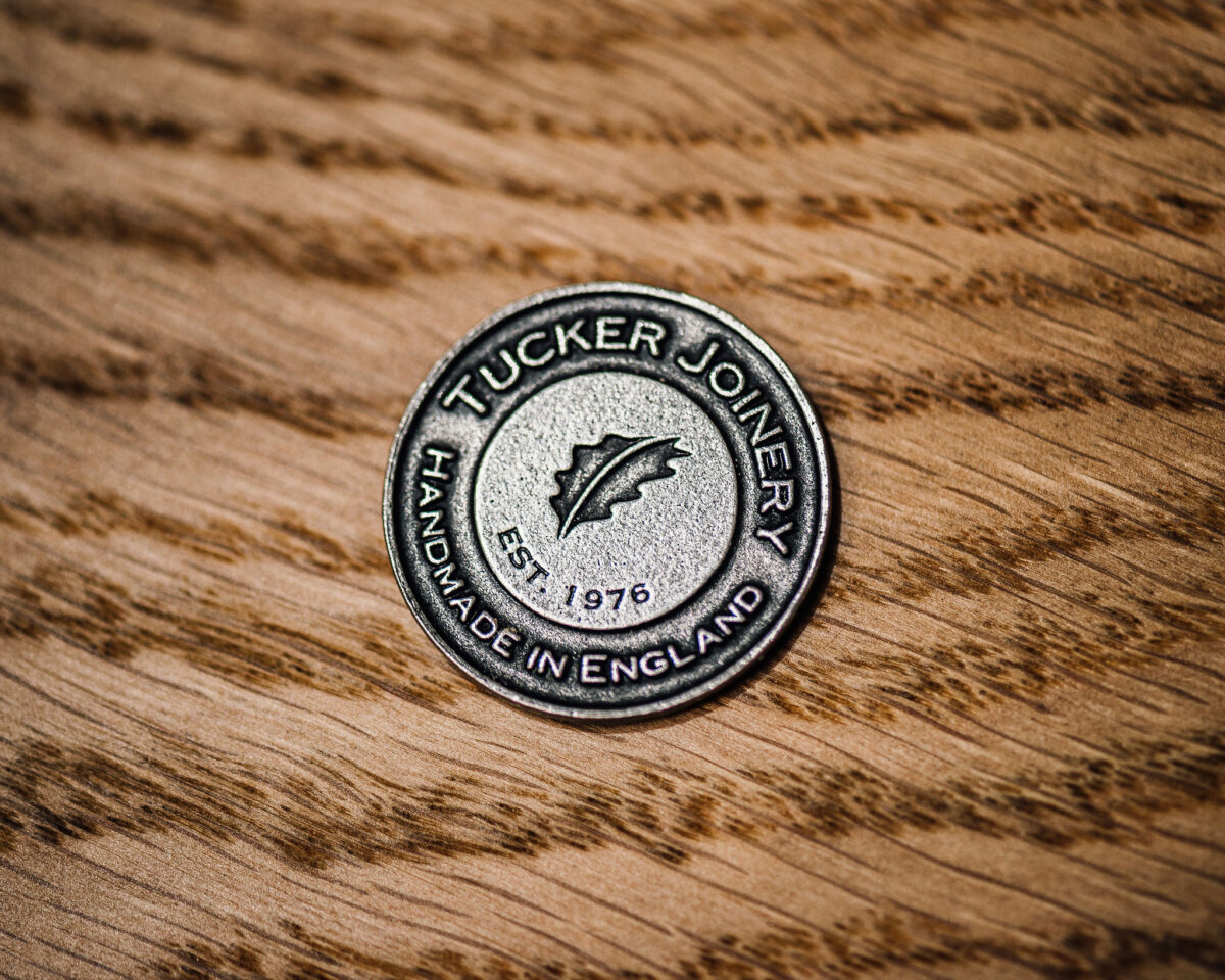 A close-up of the new Tucker Joinery branding on a small metal stamp.