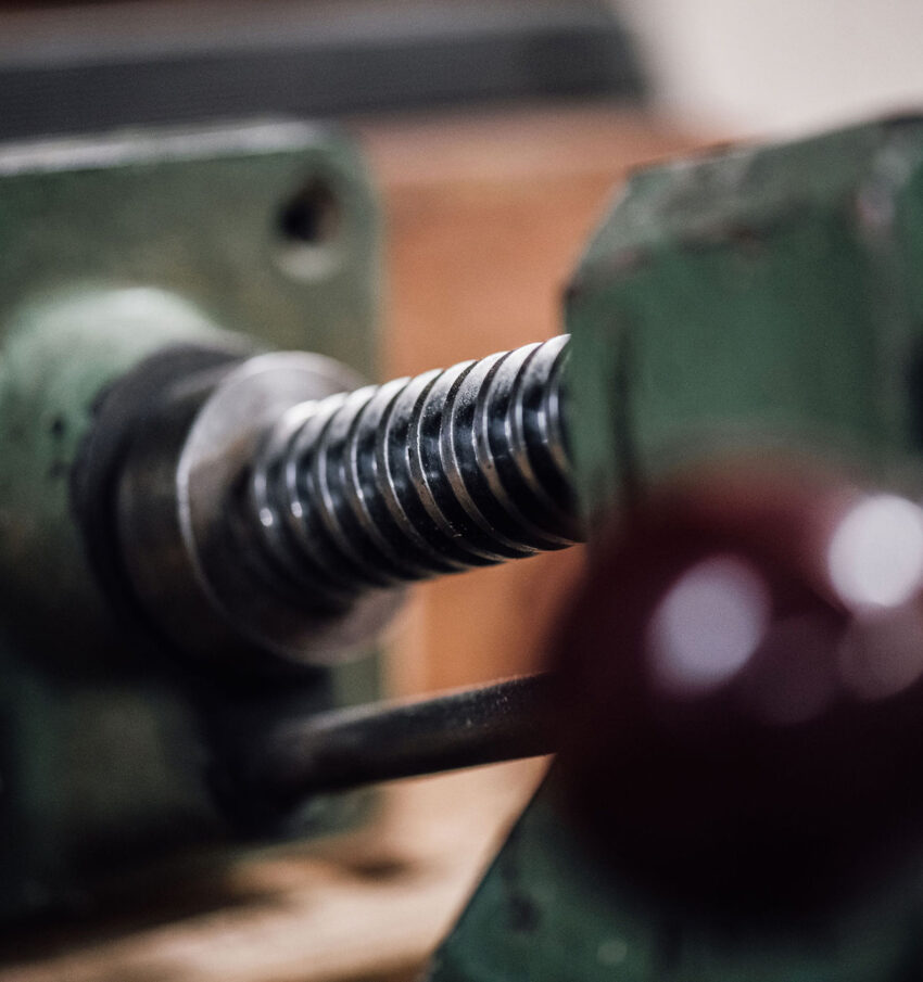 A close-up of a jaw vice, green, in the Tucker Joinery workshop based in Andover.